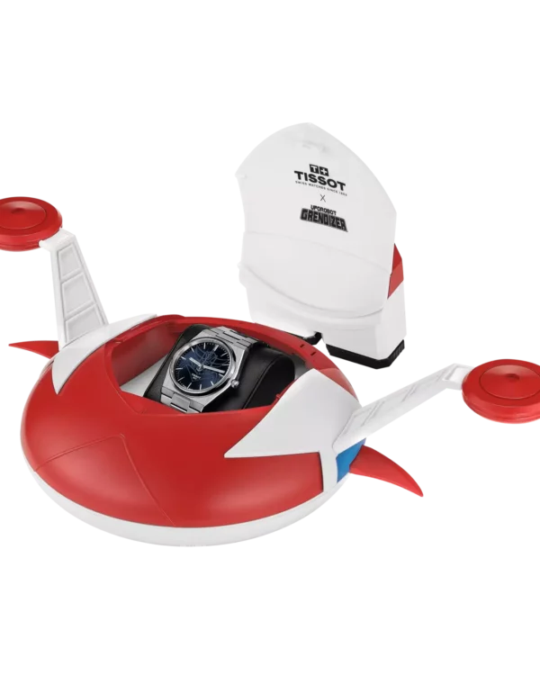 Coffret exclusif de la Tissot PRX UFO Robot Goldorak 40mm en forme d’OVTerre, avec montre automatique Powermatic 80 au cadran bleu.