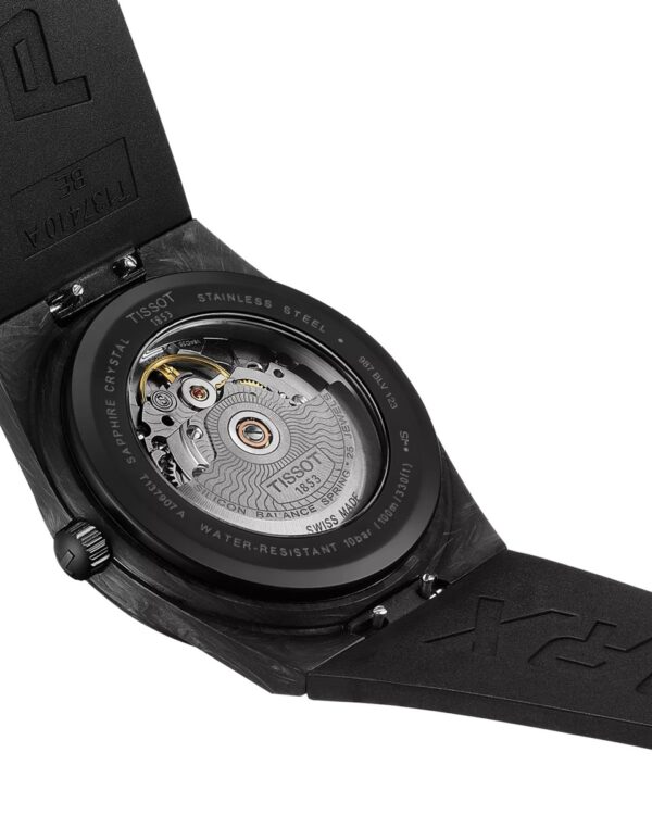 Vue arrière de la montre Tissot PRX Powermatic 80 Carbone, montrant le mouvement automatique à travers le fond saphir et le boîtier en composite de carbone noir.